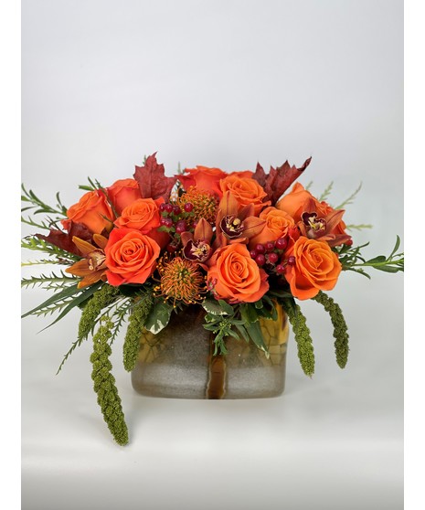 silver toned vase with dramatic flowers inside